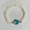 PULSERA CIRCULO FONDO BLANCO DECORADO AZUL TURQUESA