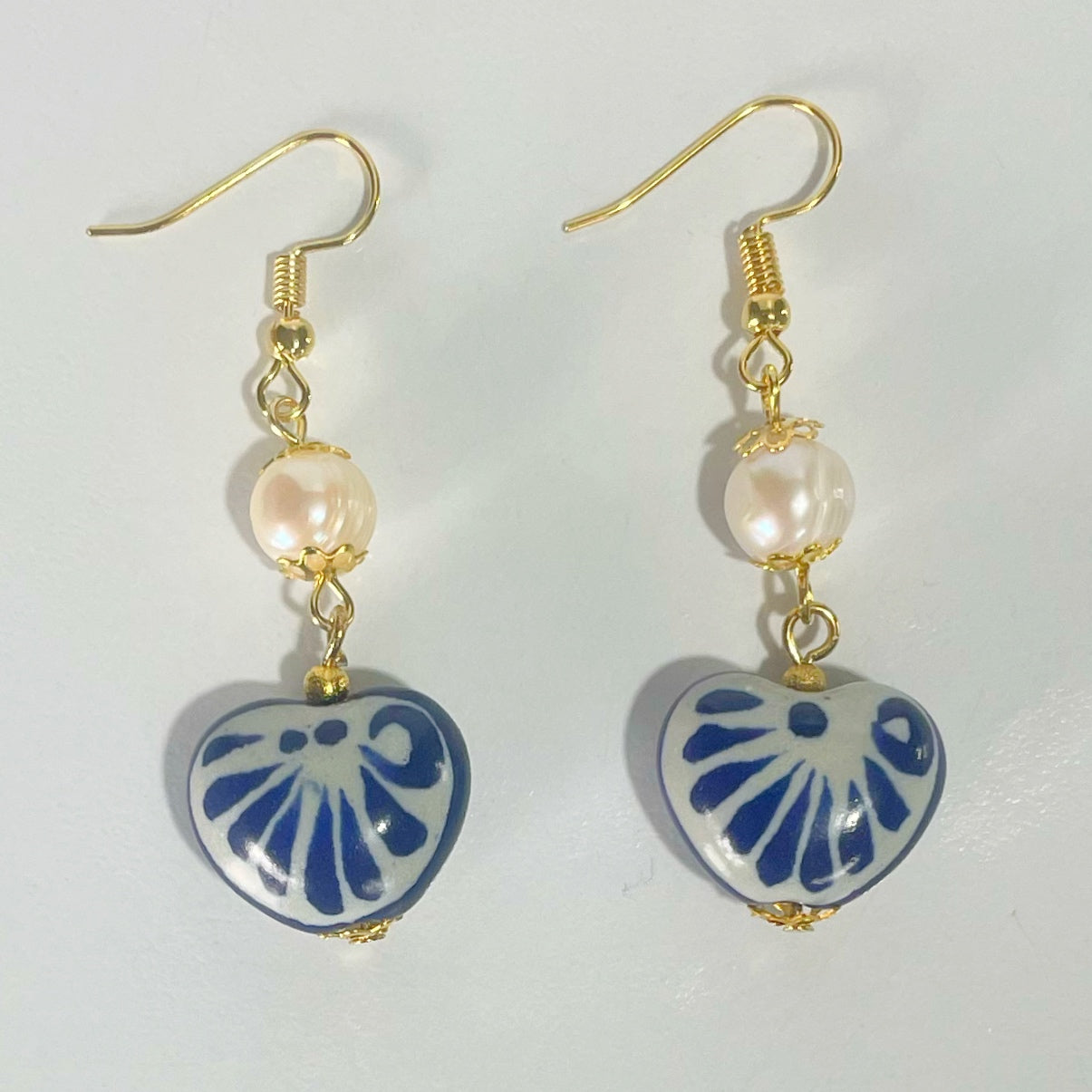 ARETES CORAZON TRIDIMENSIONAL INFLADO DECORADO AZUL COBALTO CON PERLA DEL RIO