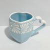 TAZA CORAZON CON ASA DE CORAZON FONDO BABY BLUE CENEFA MIK BLANCO